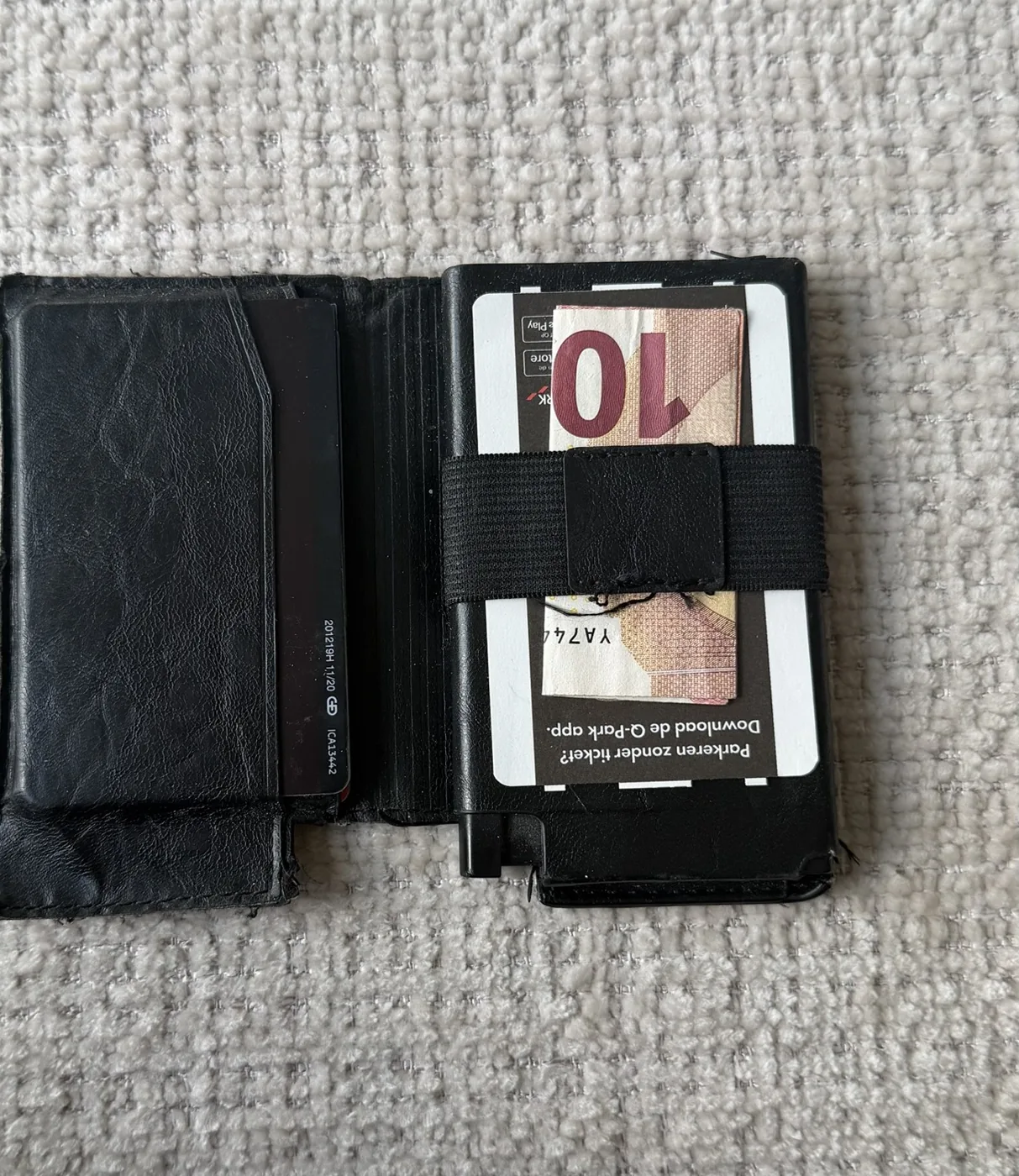 Eternity opened flat with a ten euro note under the strap